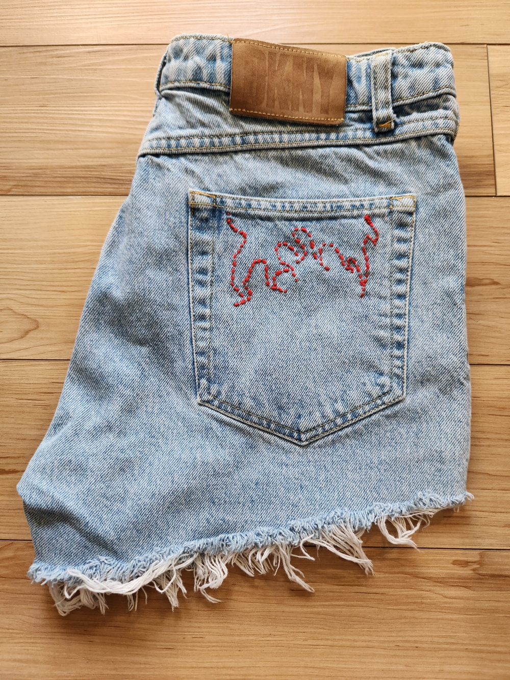 Light Wash Denim Mini Skirt with Red Embroidered Pocket
